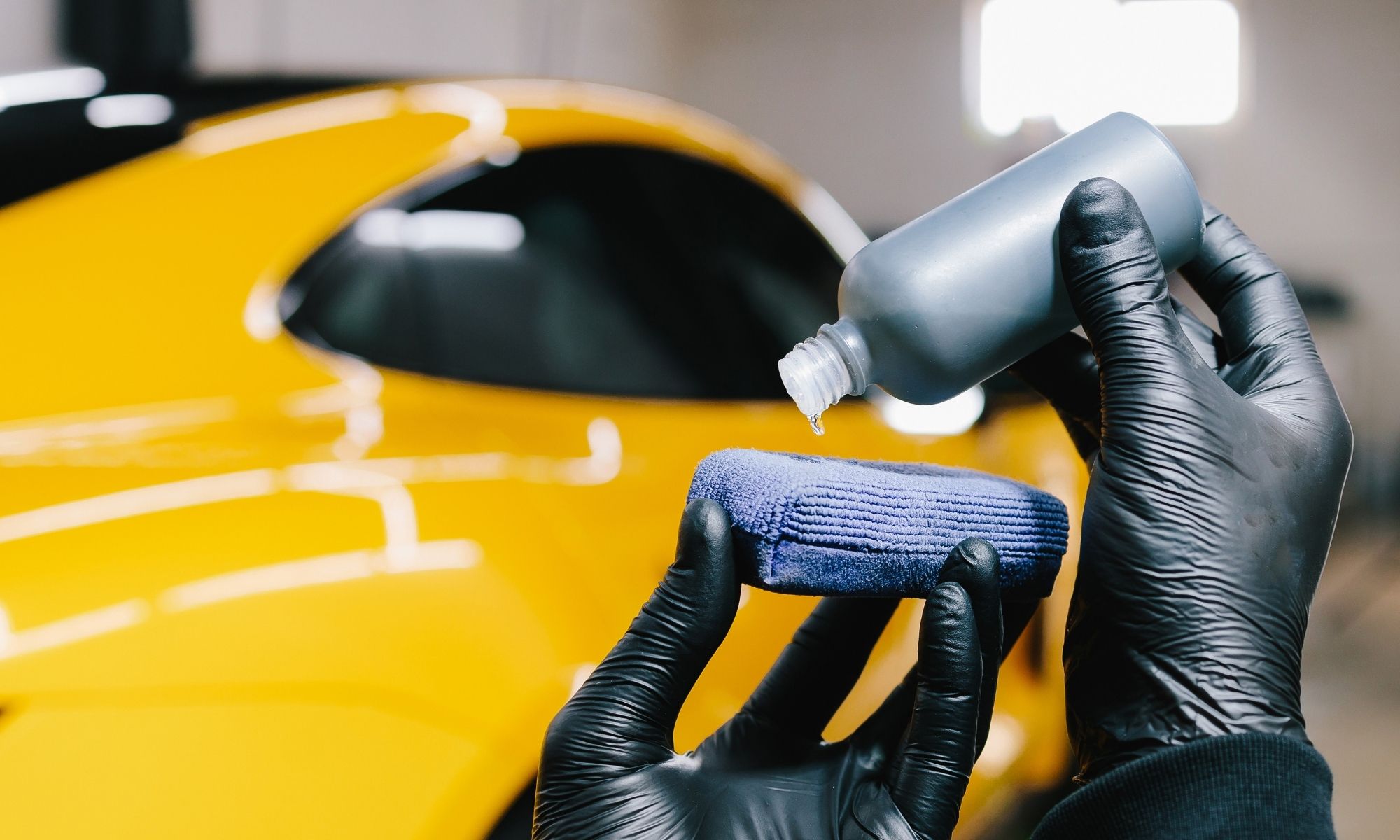 Paint sealant being applied to vehicle paint